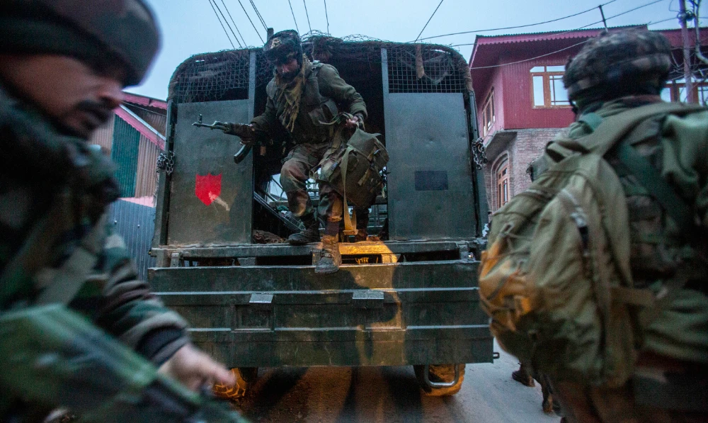 Indian army soldiers arrive during a counterinsurgency operation on the outskirts of Srinagar, Indian controlled Kashmir, on Jan. 3, 2022. (AP)