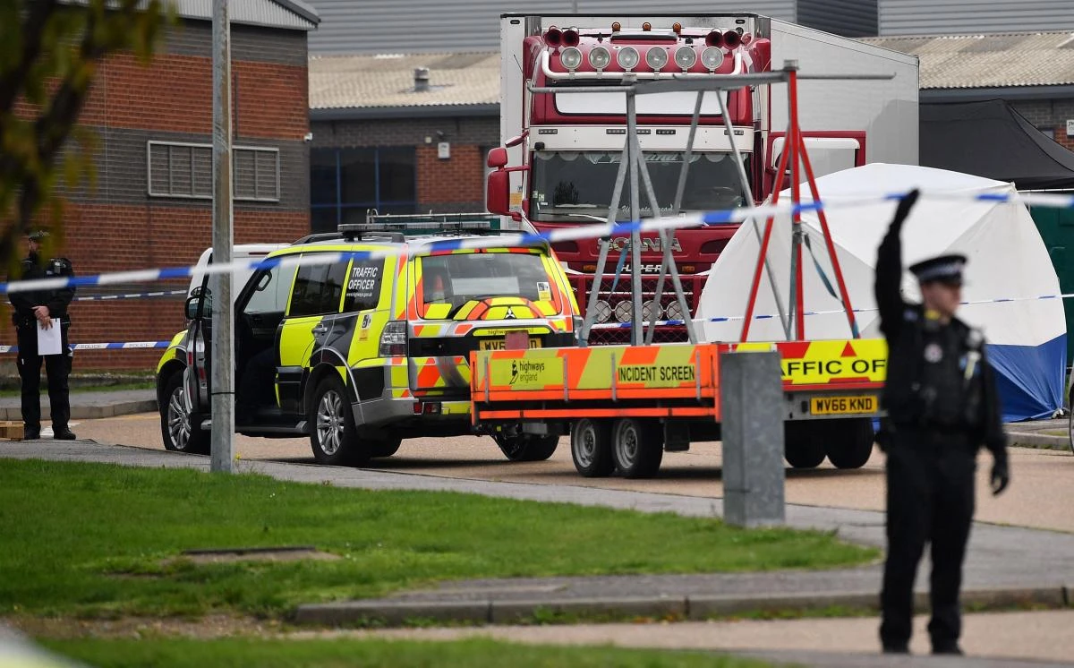 British police officers work by a lorry, believed to have originated from Bulgaria, and containing 39 dead bodies, discovered at Waterglade Industrial Park in Grays, east of London. (File/AFP)