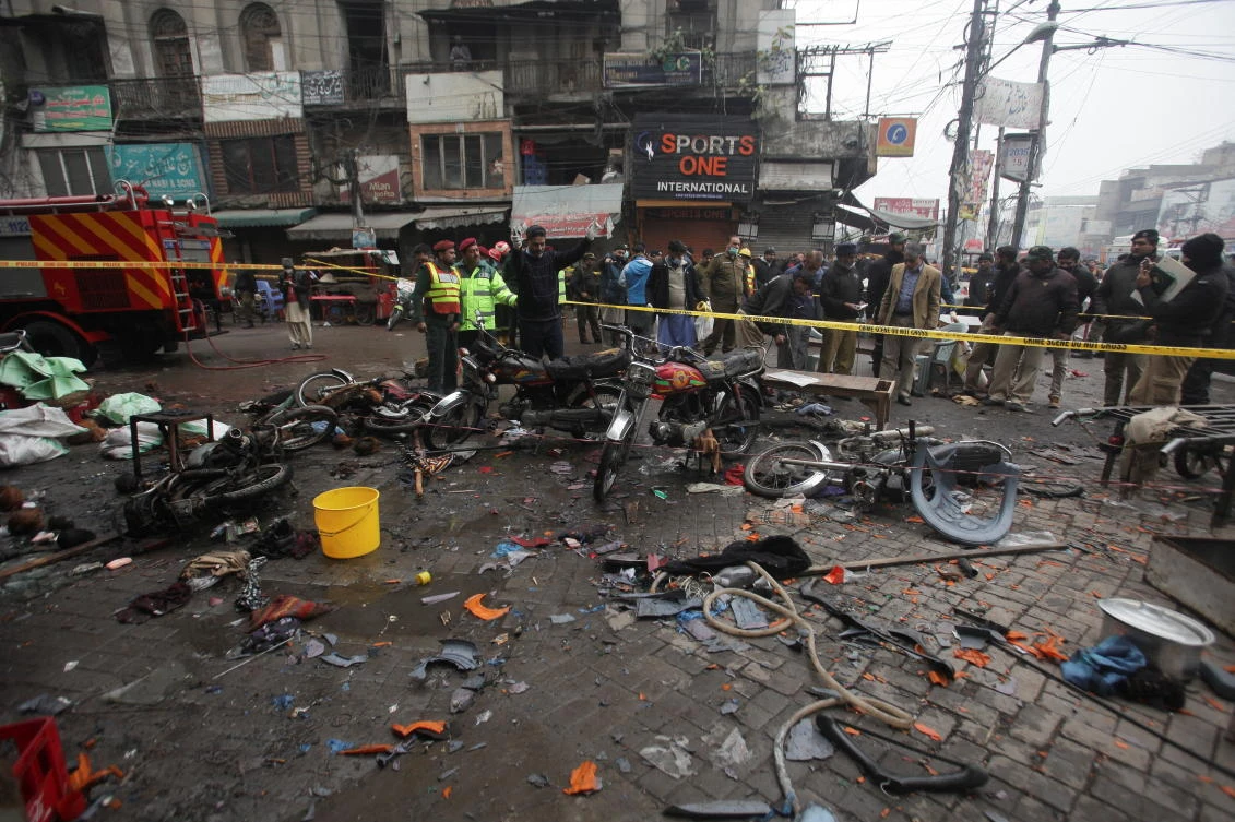 Members of crime scene unit and a bomb disposal unit survey the site after a blast in a market, in Lahore, Pakistan January 20, 2022. (Reuters)