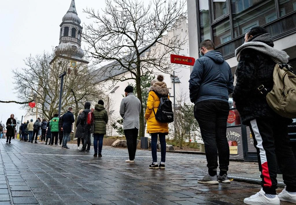 People queue for a rapid test at a test center at Budolfi Church in Aalborg, Denmark on Dec. 23, 2021. EU member Denmark has already decided to roll out a fourth dose of COVID-19 vaccines. (AFP)