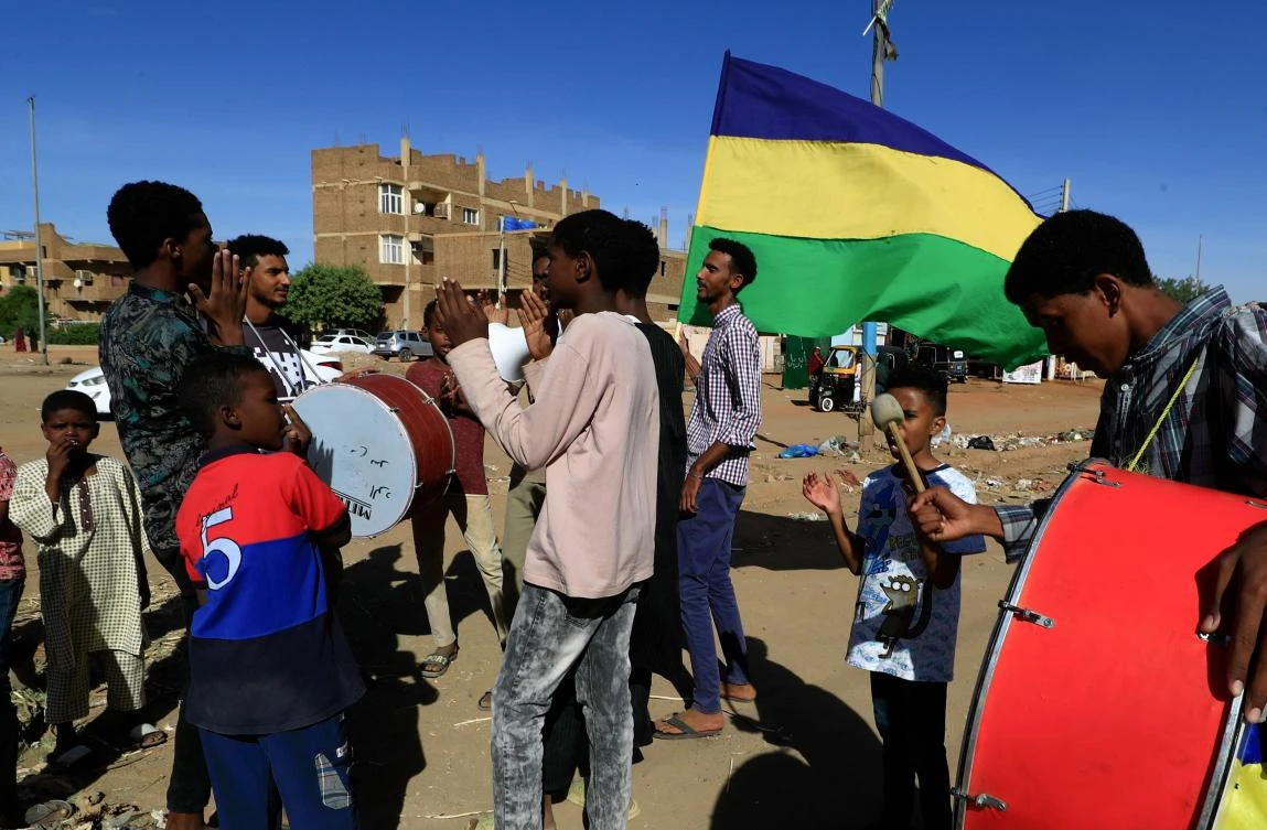 Sudanese youths beat drums and chant slogans as they tour neighbourhoods in the capital Khartoum, in support of the families of protesters killed since last year's military coup, on January 21, 2022. (AFP)