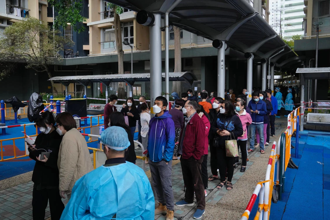 Residents line up to get tested for the coronavirus at the lockdown area in Kwai Chung Estate, in Hong Kong, Saturday, Jan. 22, 2022. (AP)