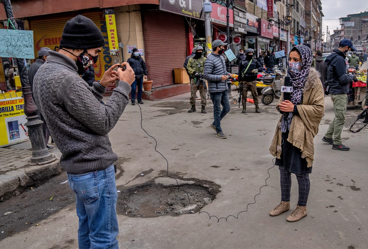 Kashmiri Journalists work during surprise search of pedestrians by security forces in Srinagar, Indian controlled Kashmir, on January 21, 2022. (AP)