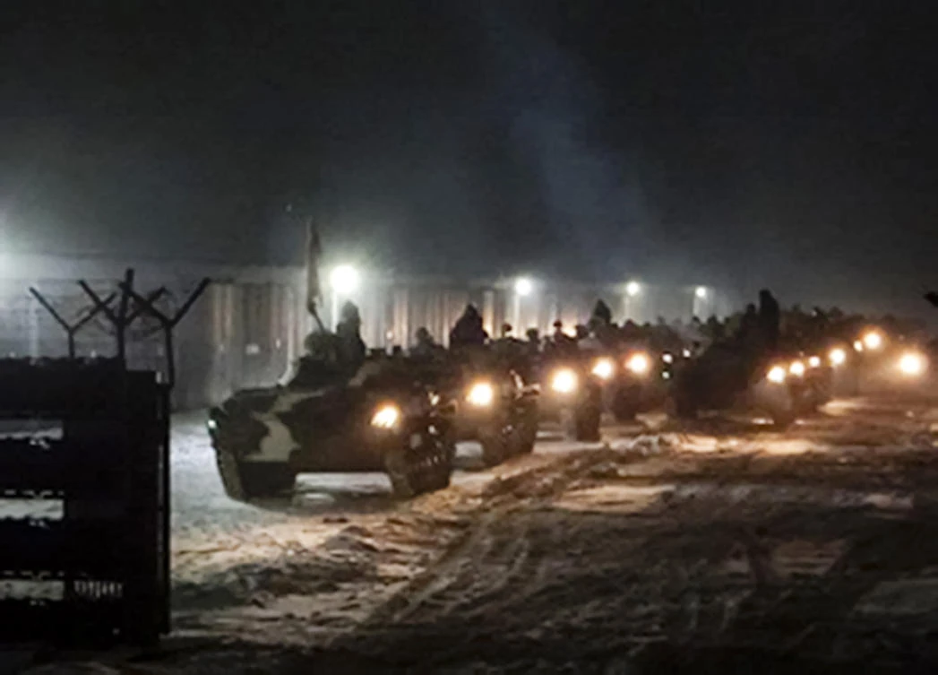 Above, Belarusian military vehicles gather preparing to attend Belarusian and Russian joint military drills in Belarus, which shares a border with Ukraine in this supplied photo on Jan. 25, 2022. (Vayar Military Agency Agency via AP)