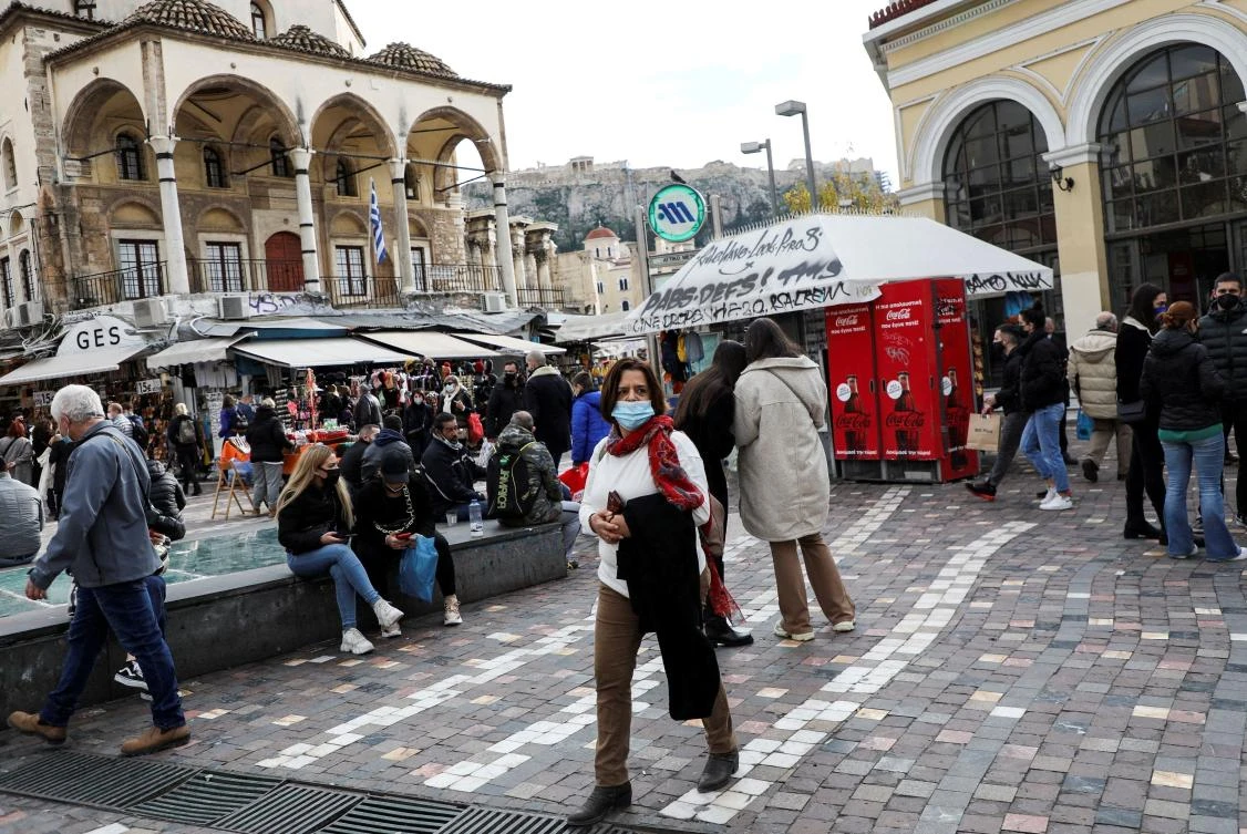People wearing protective masks make their way to Monastiraki square amid COVID-19 outbreak, in Athens in December. (Reuters)
