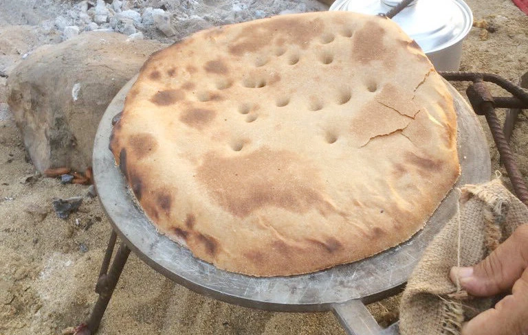 Saudi locals enjoy cooking regional dishes traditionally on wilderness trips