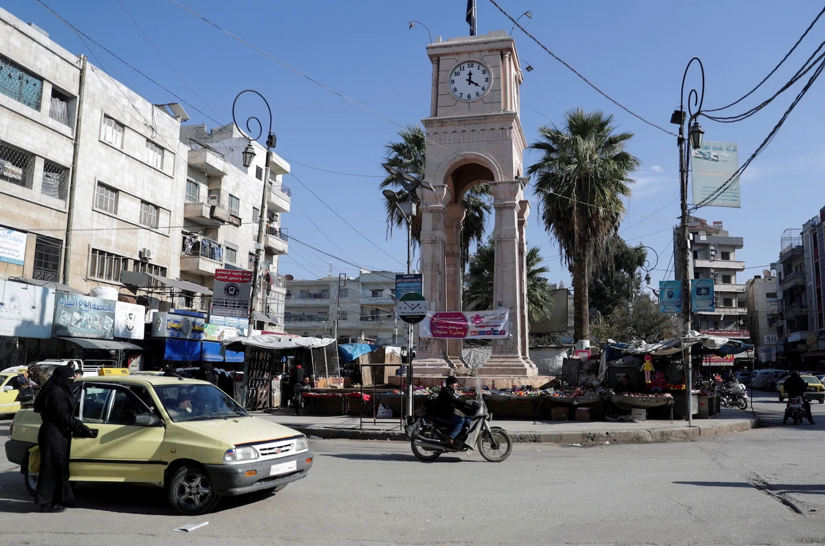 Vehicles and motorbikes drive at a roundabout in the opposition-held city of Idlib, Syria. (File/Reuters)