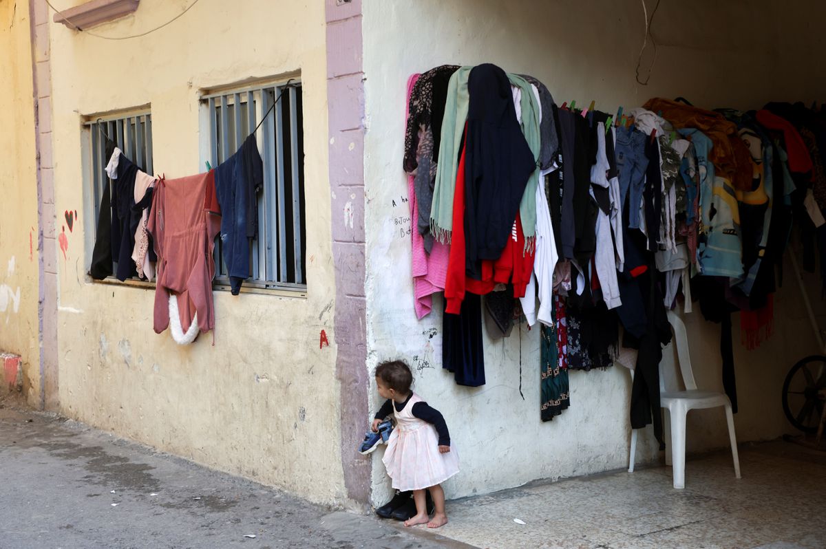 A child peeks from behind the corner of a building in Beirut’s Karantina district, Lebanon, Nov. 22, 2021. (Reuters)