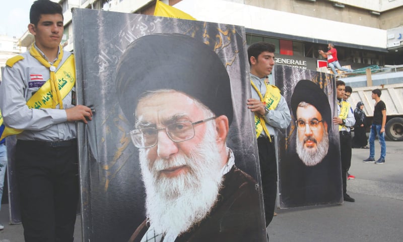Hezbollah supporters carry images of Iran’s Supreme Leader Ali Khamenei and Hezbollah leader Hasan Nasrallah, Nabatieh, Lebanon, Nov 8, 2017. (AFP)