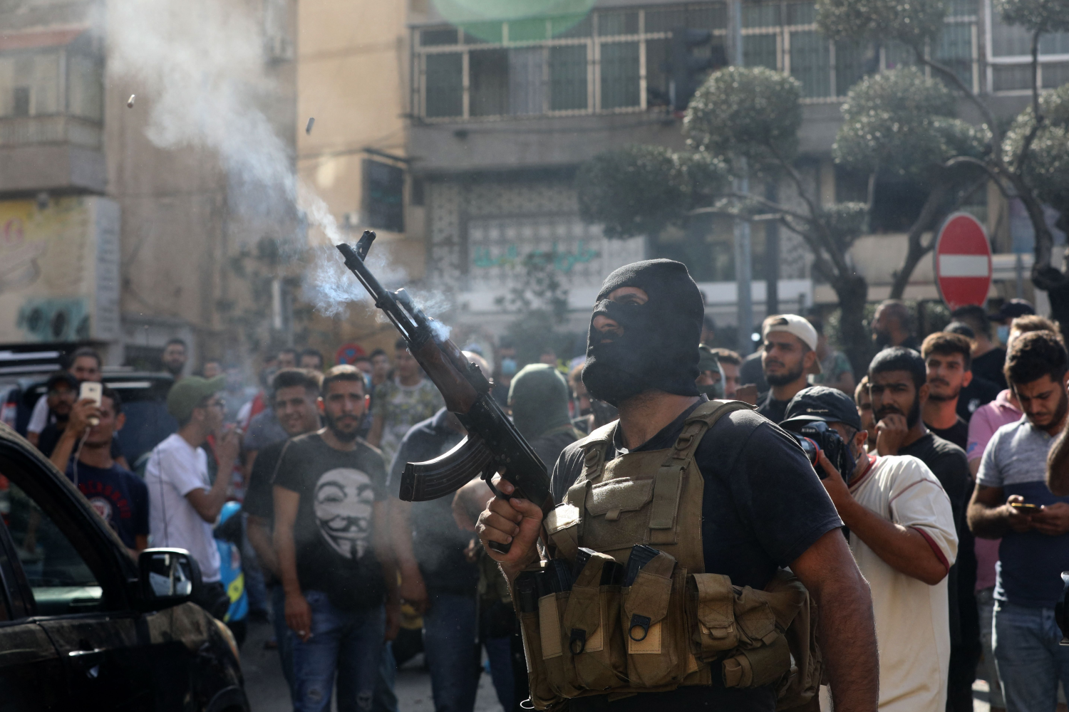 A Hezbollah fighter fires in the air during the funeral of fellow fighters, who were killed during clashes, in Beirut’s southern suburbs, Oct. 15, 2021. (AFP)