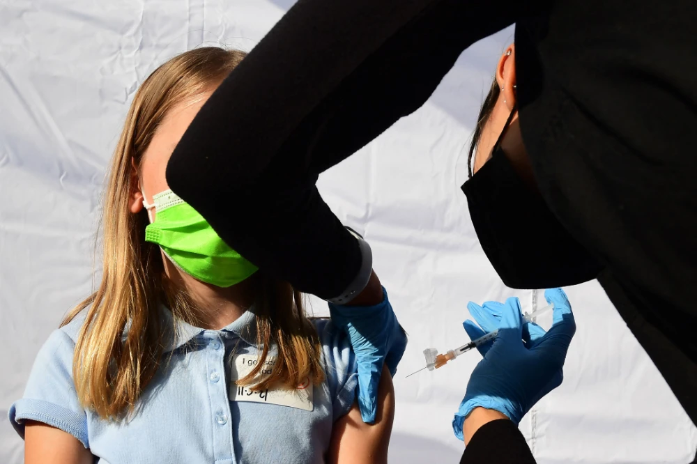A child receives a dose of Pfizer's Covid-19 vaccine at an event launching school vaccinations in Los Angeles. (AFP/File)