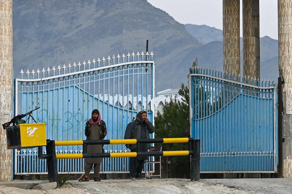 Taliban fighters stand guard at the main gate of Laghman University in Laghman province on February 2, 2022. (AFP)