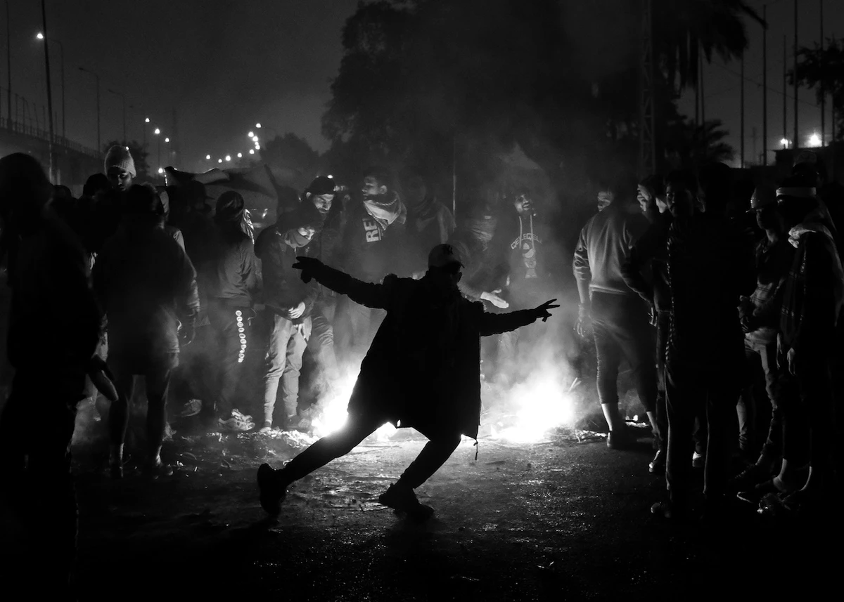‘Double Flame,’ by Amir Hazim, captures protesters gathering around a fire during a cold night, 2020. (Supplied)