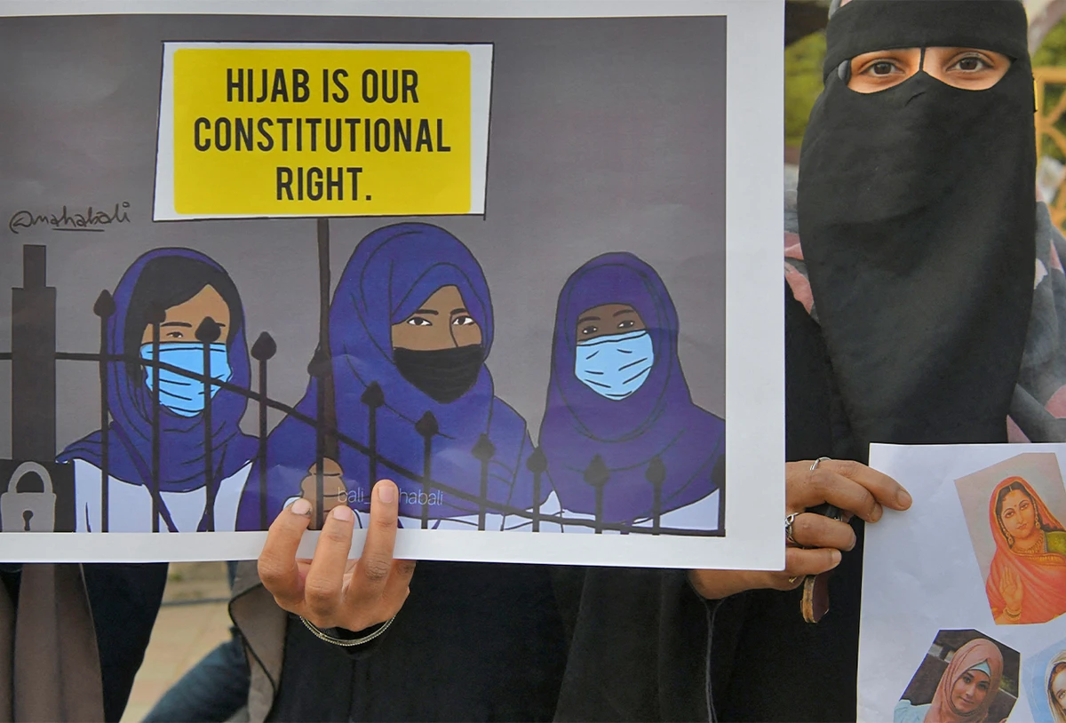 A Muslim woman holds a placard reading 'Hijab is our constitutional right' during a demonstration after educational institutes in Karnataka denied entry to students for wearing hijabs, in Bangalore, India, on February 7, 2022. (AFP)