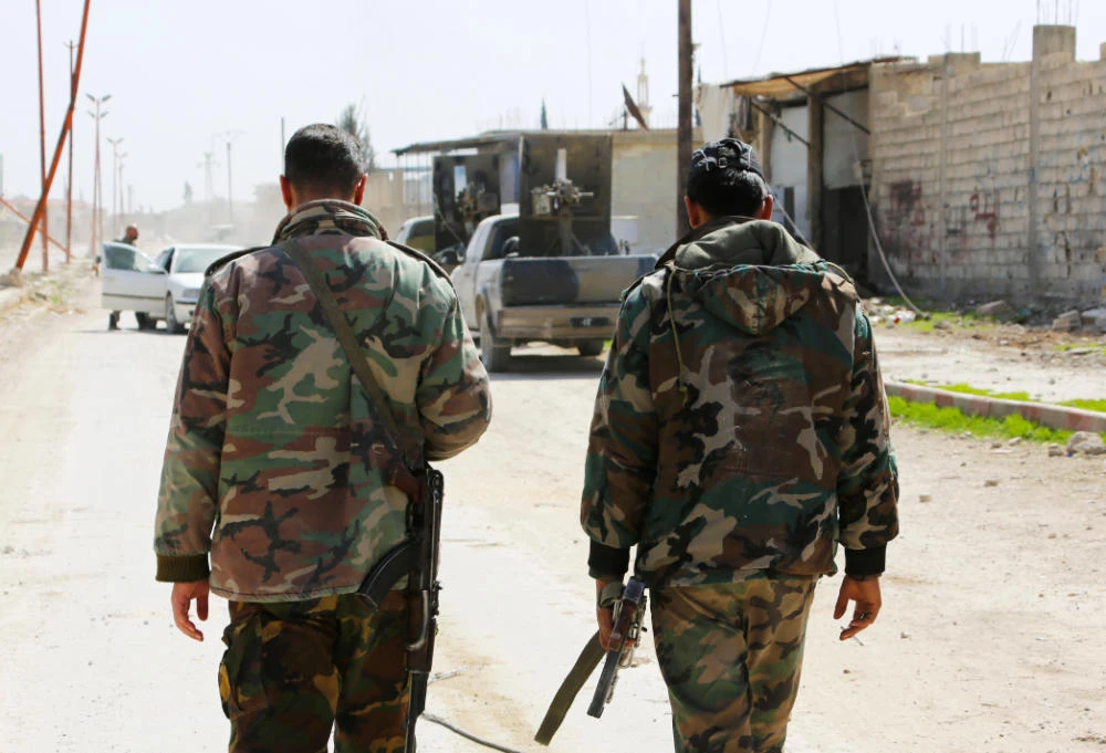 Syrian regime forces enter the village of Utaya on March 5, 2018, as they seized more ground in a fierce offensive to retake the battered rebel enclave of Eastern Ghouta. (AFP)