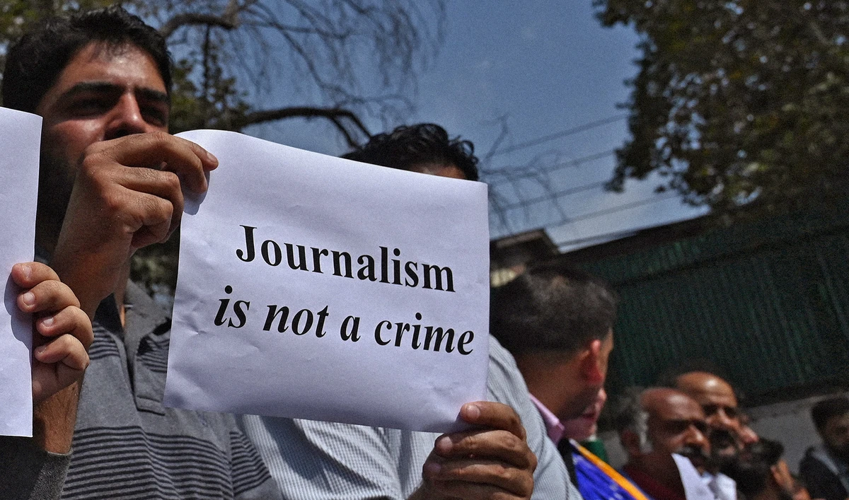 Journalists hold signs during a protest against the restrictions of the Internet and mobile phone networks during a lockdown in Srinagar, Indian-administered Kashmir, on October 3, 2019. (AFP/File)