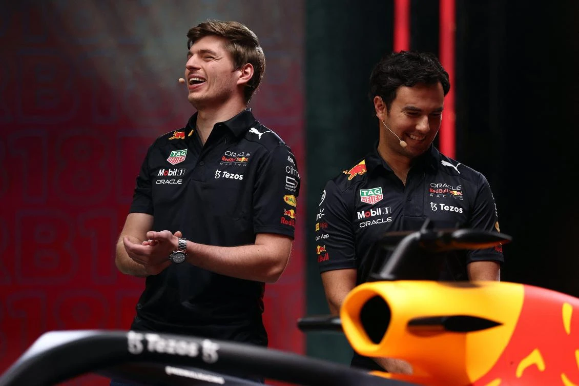 A handout photograph released on Wednesday by Red Bull shows Formula one Dutch driver Max Verstappen and Mexican driver Sergio Perez attending the launching of the new Red Bull Racing RB18 car in Milton Keynes. (AFP)