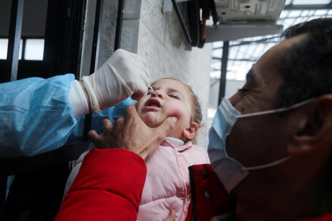 A Palestinian girl is tested for COVID-19 in light of the outbreak in Nablus, the Israeli-occupied West Bank, on Monday. (Reuters)