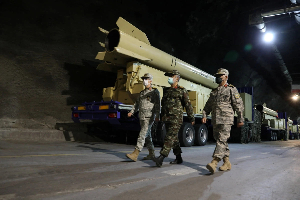 Iran's military chief Mohammad Bagheri and IRGC Aerospace Force Commander Amir Ali Hajizadeh walk during the unveiling of "Kheibarshekan" missile at an undisclosed location in Iran. (IRGC/WANA/Handout via REUTERS)