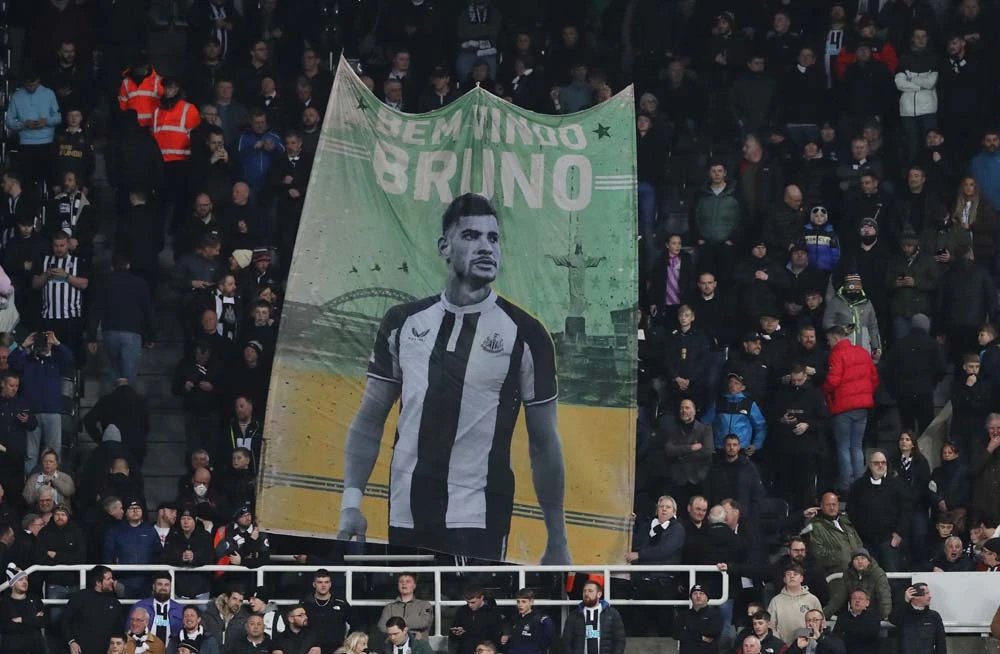 Newcastle United fans display a giant banner bearing an image of Bruno Guimaraes before the match against Everton, St. James’ Park, Newcastle, England, Feb. 8, 2022. (Reuters)