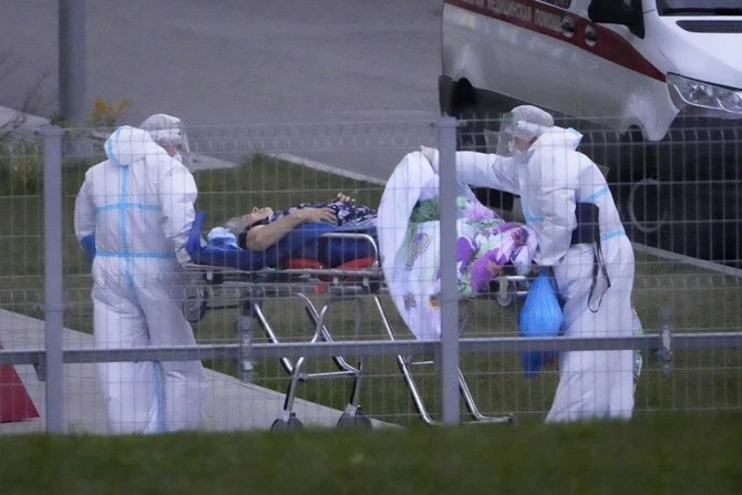 Medical workers carry a Covid-19 patient on a stretcher at a hospital in October in Russia, where authorities on Thursday reported nearly 200,000 new confirmed coronavirus cases. (AP)