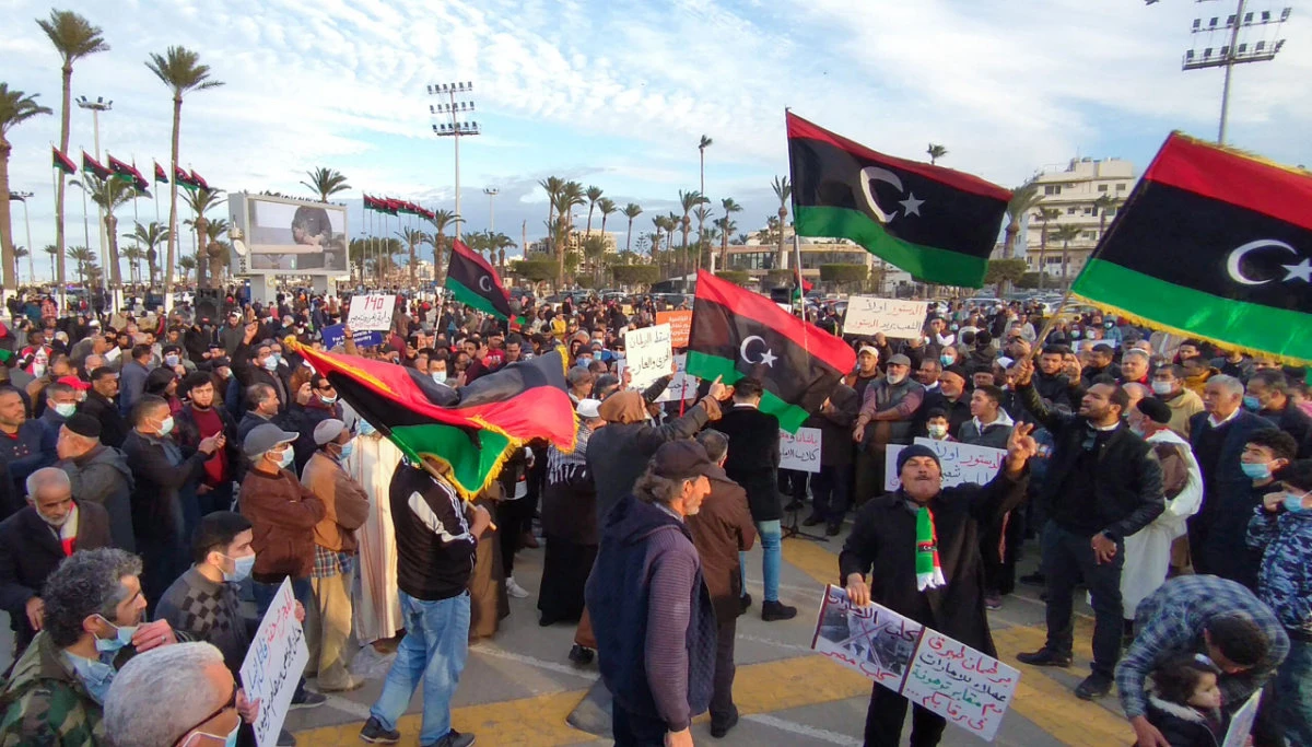 Libyans demonstrate outside the Parliament in Tripoli on Feb.11, 2022 demanding elections and calling for respect of the country's constitution. (AFP)