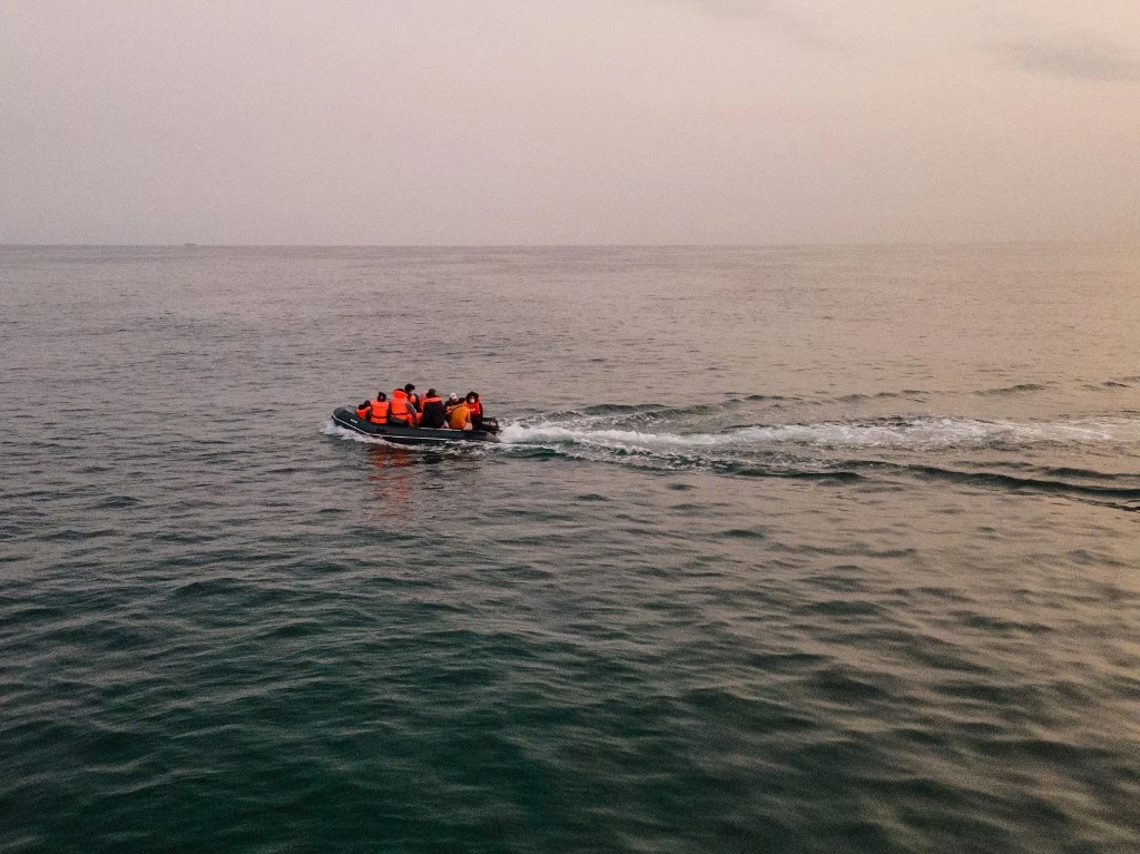 Migrants in a dinghy wear life jackets as they illegally cross the English Channel from France to Britain. (File/AFP)