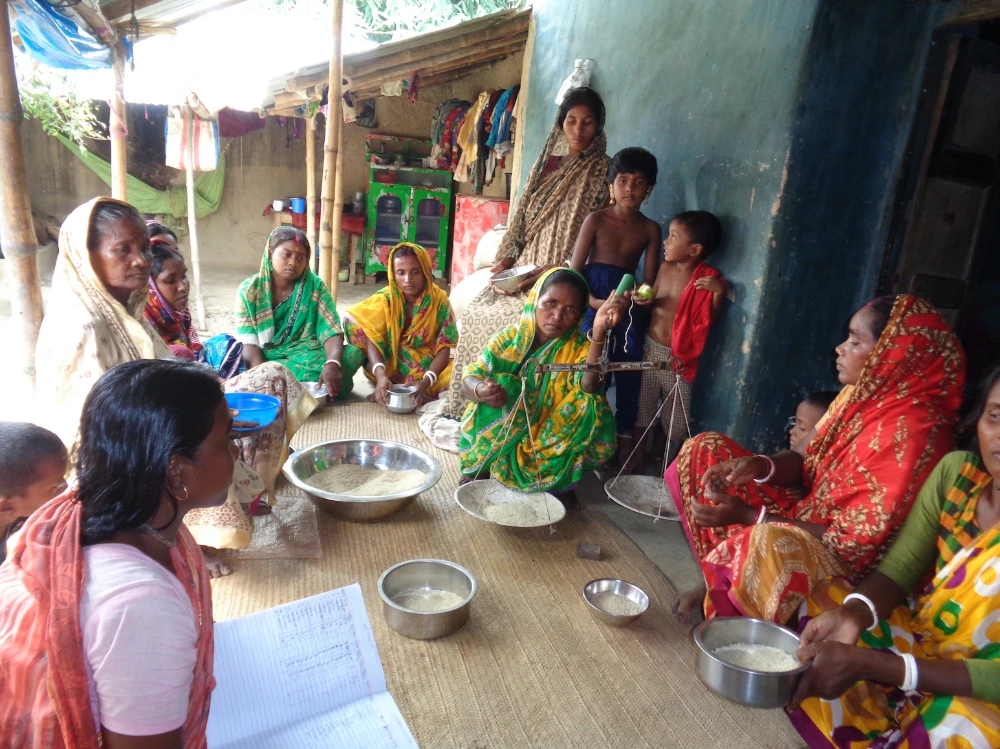 Indigenous women meet to donate their weekly portion of rice to a community food bank in Naogaon district, northern Bangladesh. (Photo: Borendro Development Organization)