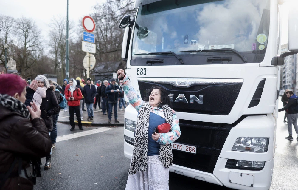 A protester shouts slogans during an unauthorised demonstration of participants of the so-called "Freedom Convoy" (Convoi de la Liberte) in the center of Bruxelles on February 14, 2022 to protest against coronavirus disease. (AFP)