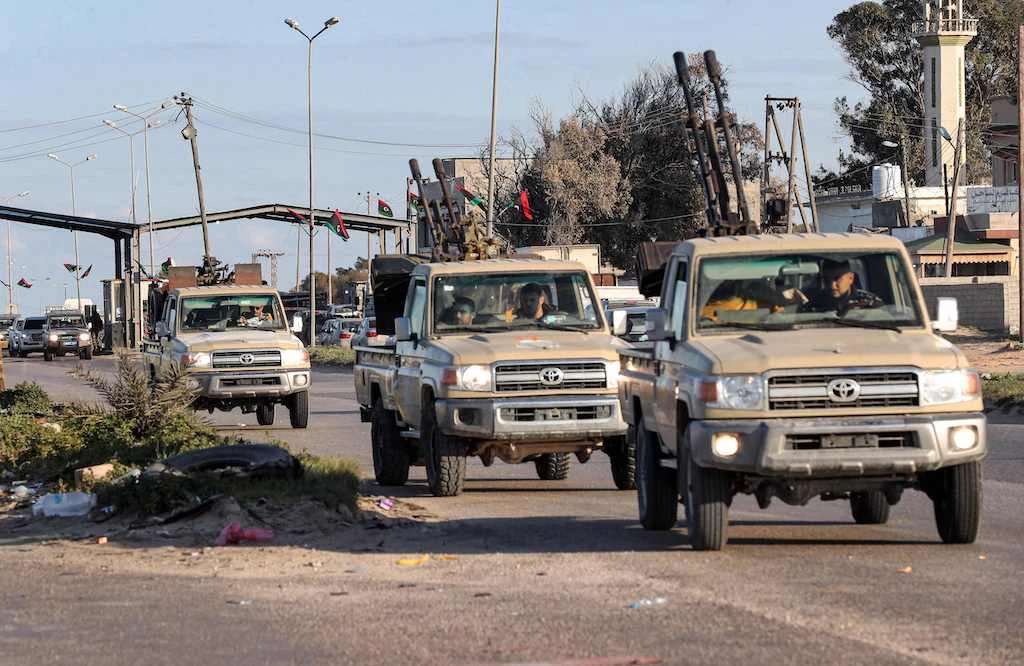 Vehicles of military brigades loyal to the Libyan unity government headed by Abdulhamid Dbeibah arrive from neighbouring towns to the capital Tripoli on February 12, 2022. (AFP)