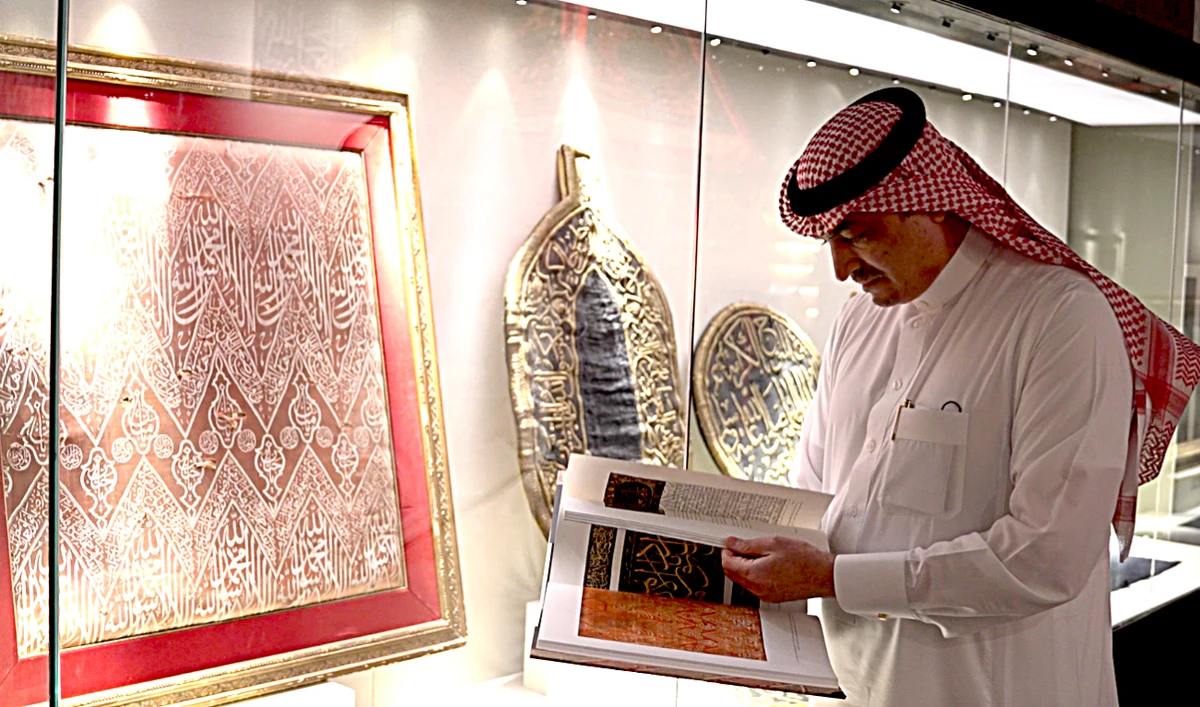 Anas Serafi, the son of the museum’s founder, next to the rare red Kaaba interior textile at House of Islamic Arts museum.