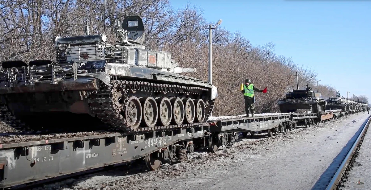 Russian army tanks are loaded onto railway platforms to move back to their permanent base after drills in Russia. (AP)