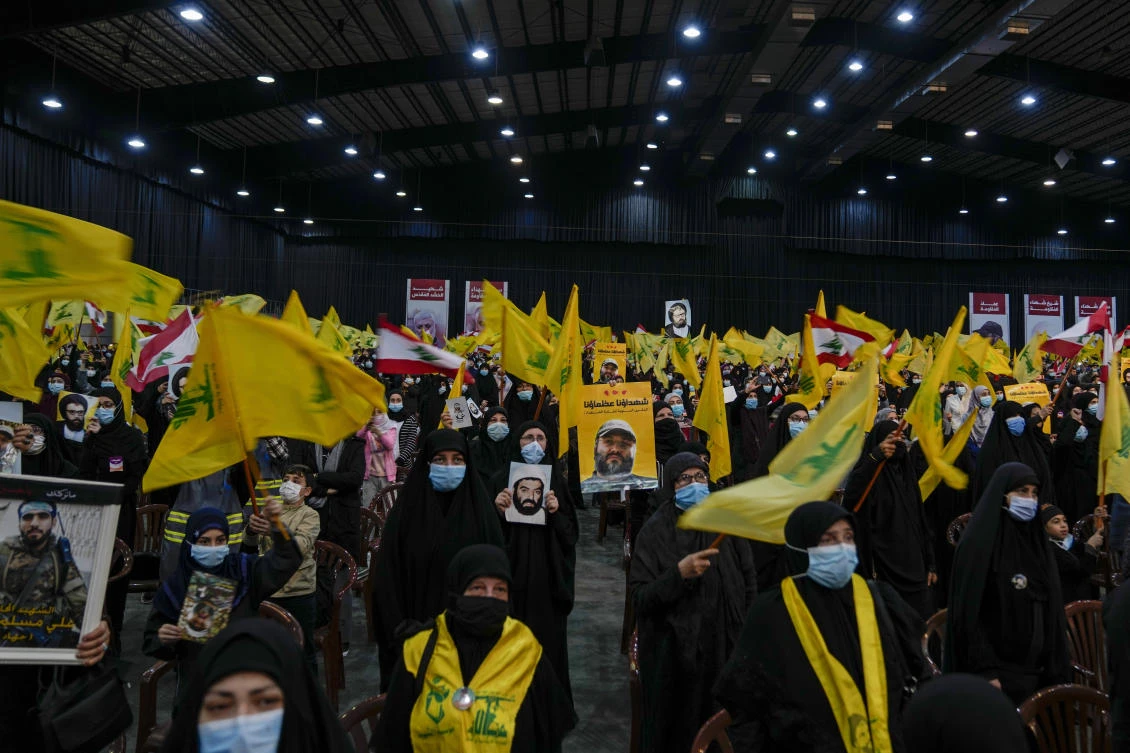 Hezbollah supporters sing the Lebanese and Hezbollah anthems during an annual ceremony commemorating the killing of some of the Iran-backed group’s top political and military leaders in Lebanon on Wednesday. (AP)
