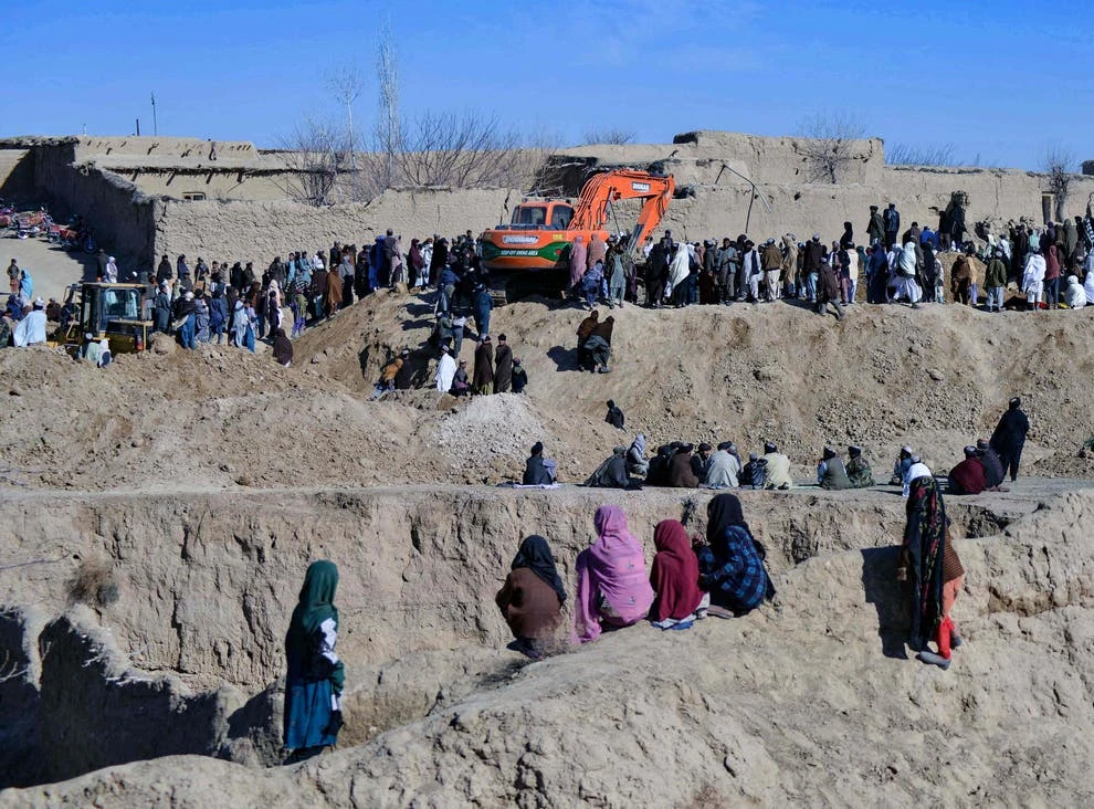 Afghan people gather as rescuers try to reach and rescue a boy trapped for two days down a well in a remote southern Afghan village of Shokak, in Zabul province about 120 Kms from Kandahar on February 17, 2022. (AFP)
