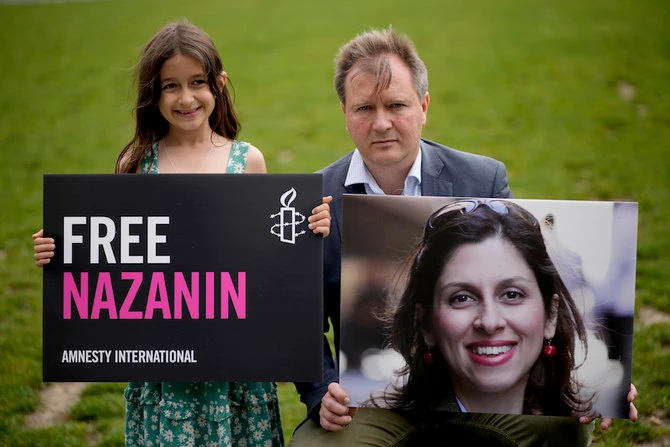 Richard Ratcliffe, husband of imprisoned British-Iranian Nazanin Zaghari-Ratcliffe, and their daughter Gabriella in Parliament Square, London, in September, 2021. (AP/File Photo)
