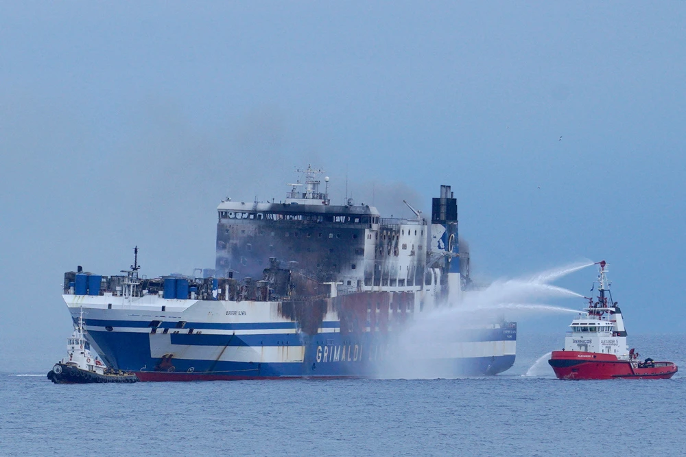 Smoke rises from the Italian-flagged Euroferry Olympia, which sailed from Greece to Italy early on Friday and caught fire, off the coast of the island of Corfu, Greece, Feb. 20, 2022. (Reuters)