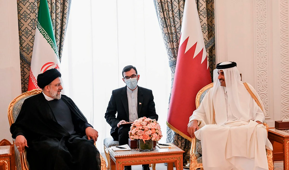 Iranian President Ebrahim Raisi, left, meets with Qatari Emir Tamim bin Hamad Al Thani, in Doha, Qatar, Monday, Feb. 21, 2022. (AP)