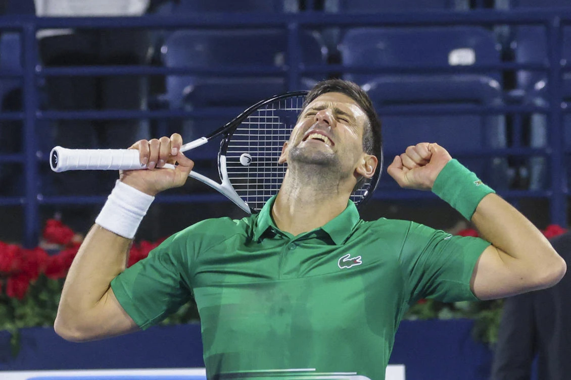 Novak Djokovic of Serbia celebrates after winning the ATP Dubai Duty Free Tennis Championship round of 32 match against Lorenzo Musetti of Italy in Dubai on Monday. (AFP)