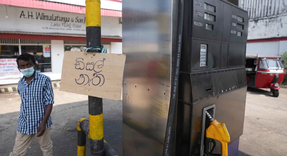 A notice written in Sinhala reads ‘No Diesel’ hangs on a fuel pumping station during a power cut in Colomb on Wednesday. (AP)