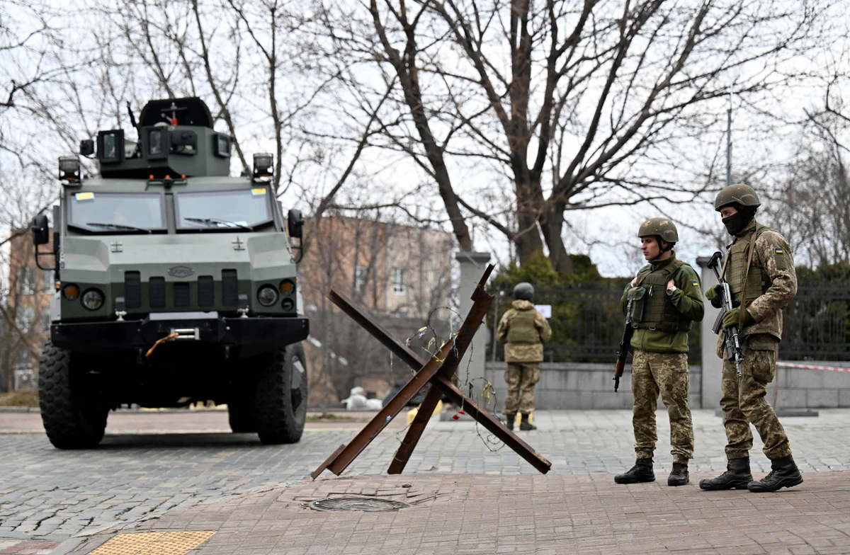Ukrainian Military Forces servicemen block a road in the so-called government quarter in Kyiv on February 24, 2022 as Russia's ground forces invaded Ukraine from several directions. (AFP)