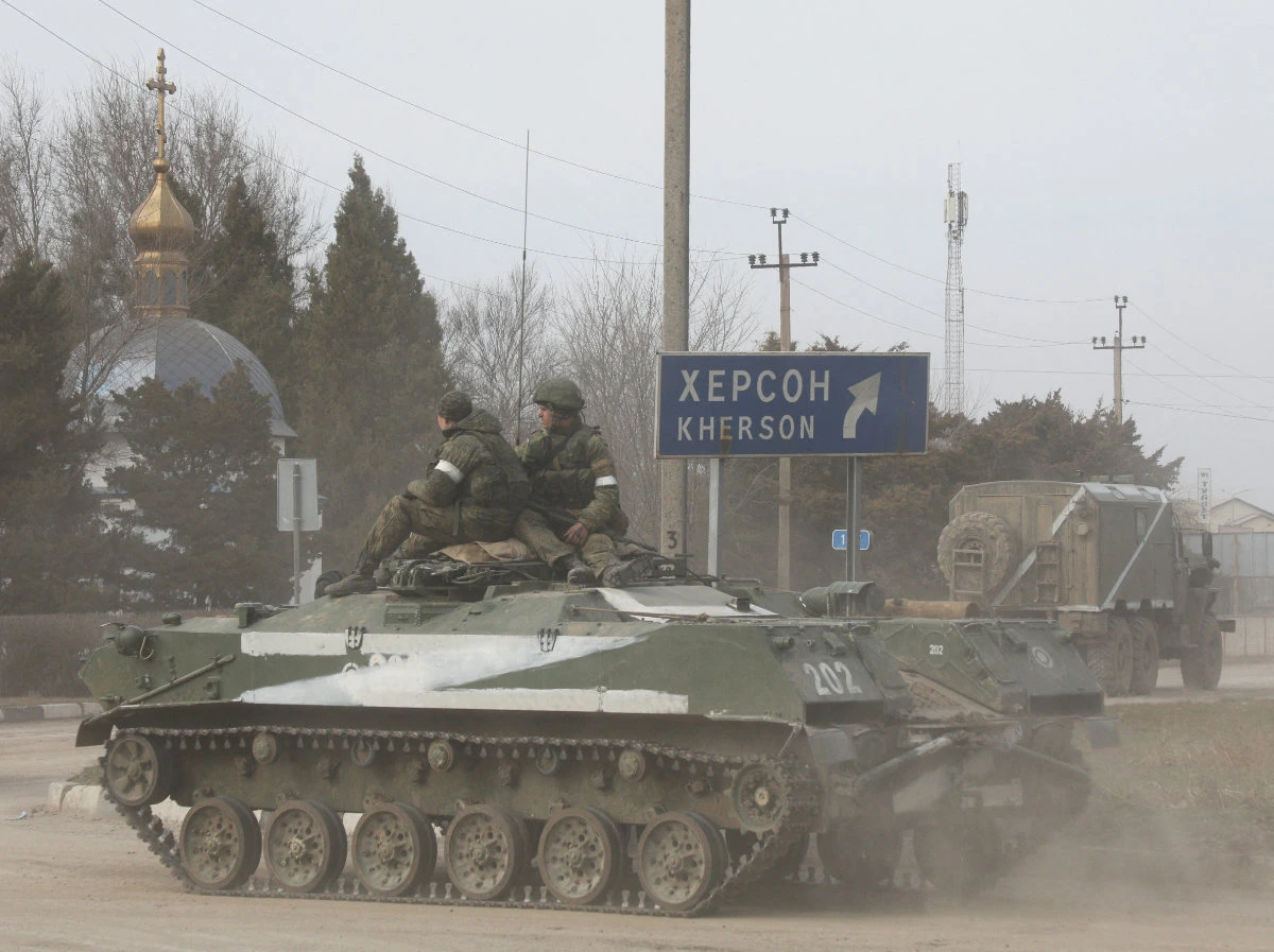 Russian soldiers ride on an armored vehicle in Armyansk, Crimea, on Feb. 24, 2022 after Vladimir Putin authorized an invasion of Ukraine. (REUTERS)