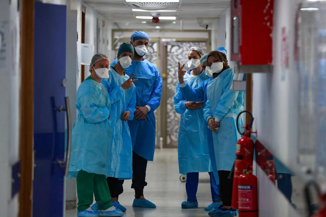 Iraqi medical workers are pictured at the coronavirus ward of Al-Shifa Hospital in the capital Baghdad, on February 20, 2022. Half of the 40 intensive care beds in Baghdad’s Al-Shifa Hospital are occupied. (AFP)