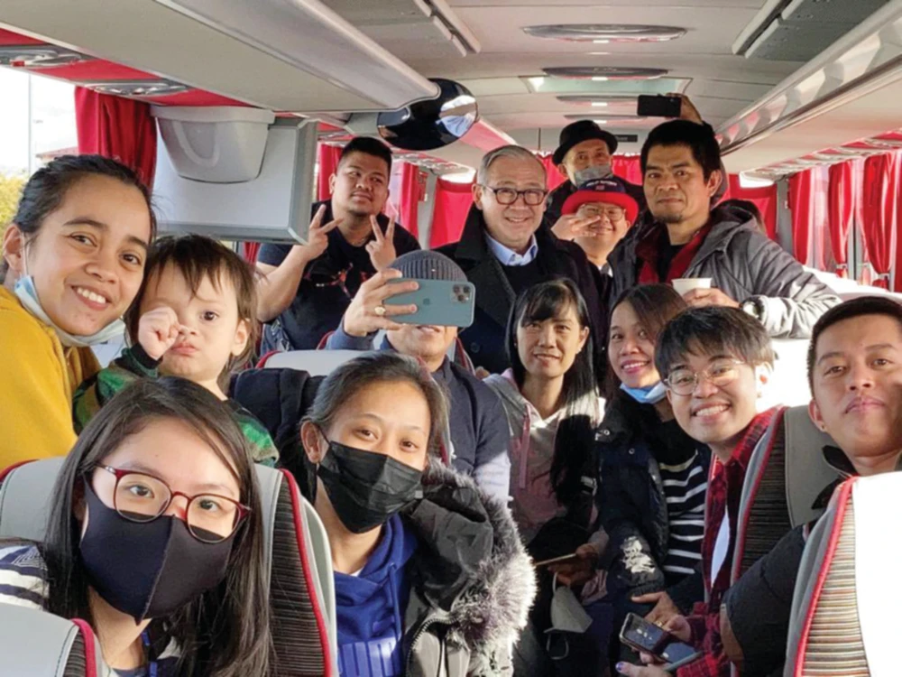 Philippine Foreign Secretary Teodoro Locsin receives 13 Filipino evacuees who crossed into Poland from Lviv in Ukraine on Sunday. (Supplied)