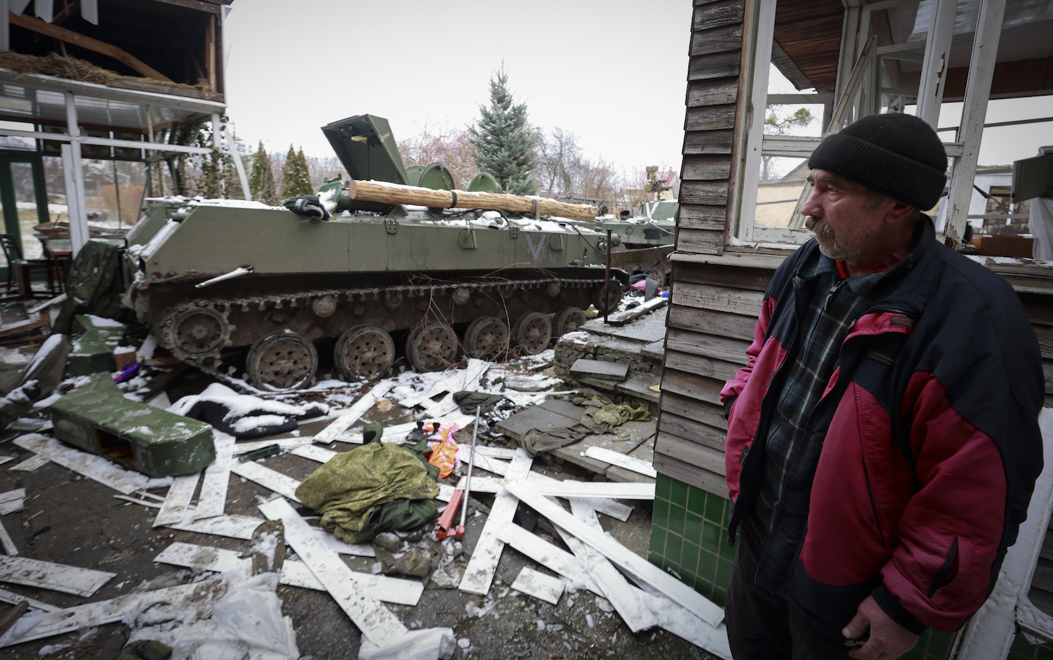 A man looks at the gutted remains of Russian military vehicles on a road in the town of Bucha, close to the capital Kyiv, Ukraine, Tuesday, March 1, 2022. (AP)