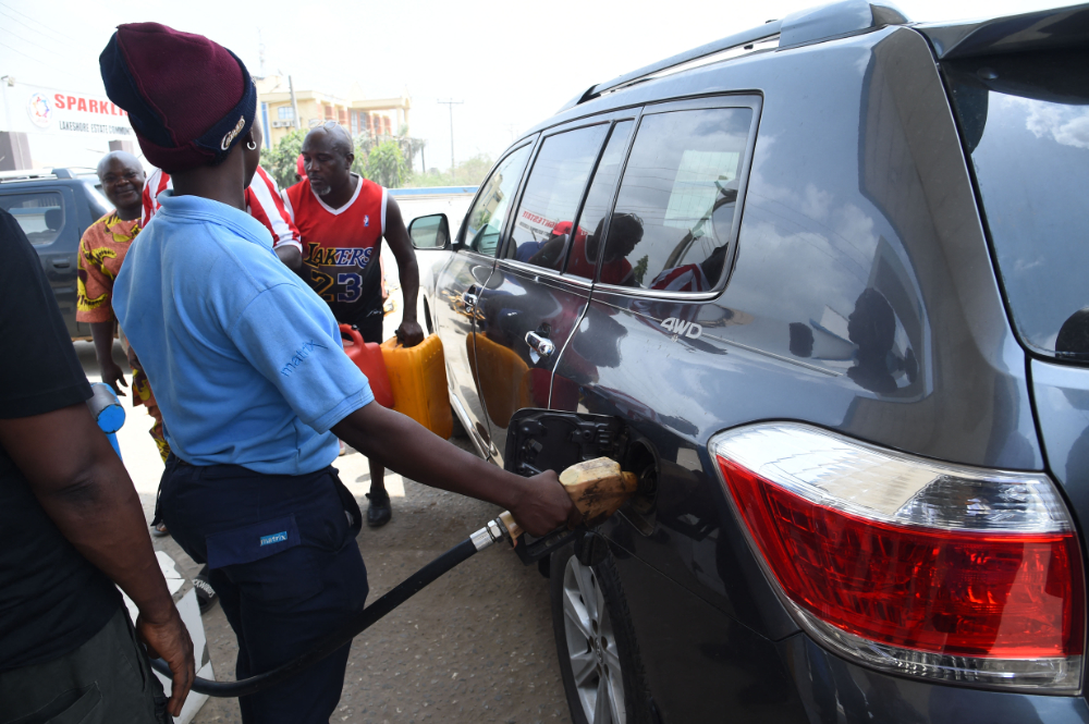 An attendant sell fuel to a motorist at filling stations along Lagos Ibadan expressway, on March 3, 2022. (AFP)