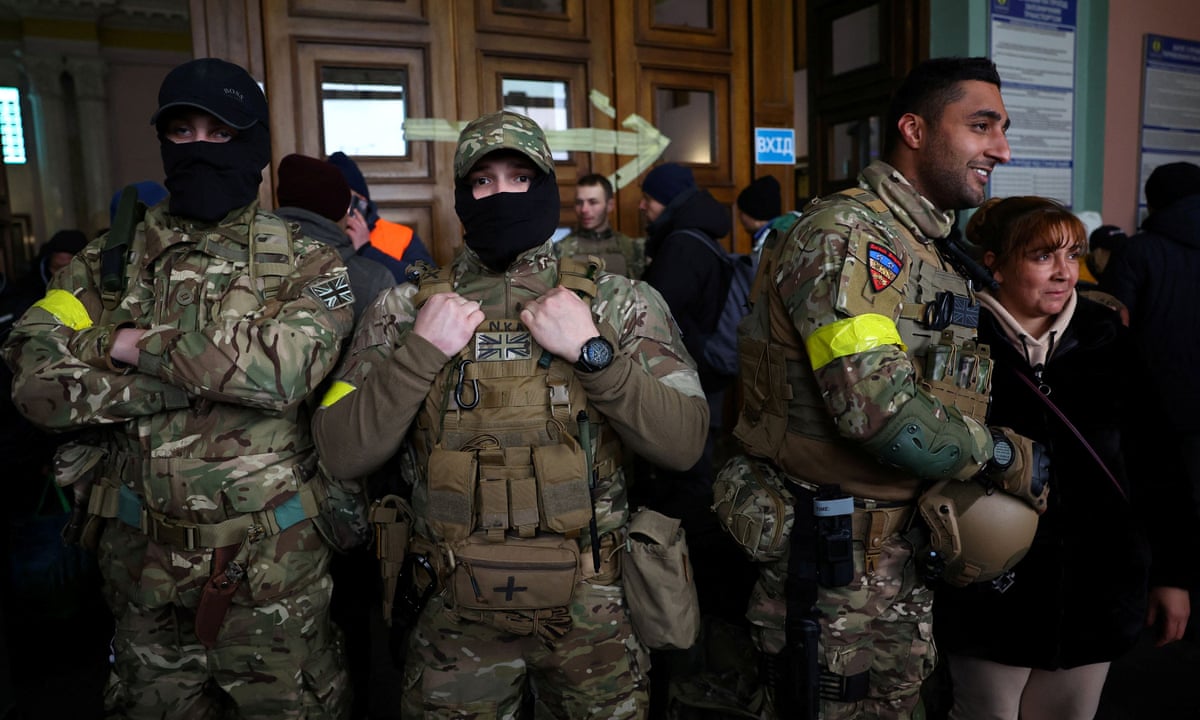 UK ex-service personnel, including former marine Ben Grant, right, in Lviv as they prepare to depart for the frontline. (Reuters)