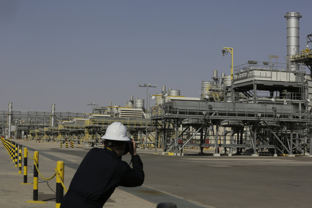 A photographer takes pictures of the Khurais oil field during a tour for journalists, 150 km east-northeast of Riyadh, Saudi Arabia. (AP/File)