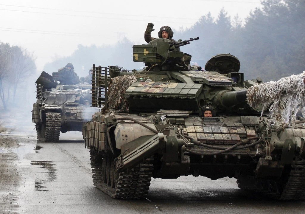 Above, Ukrainian servicemen ride on tanks towards the front line with Russian forces in the Lugansk region of Ukraine on Feb. 25, 2022. (AFP)