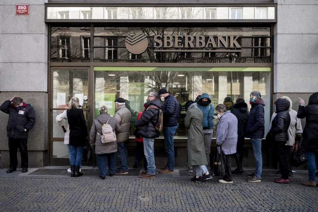 People queueing on Feb. 25 outside a branch of Russian state-owned bank Sberbank in Prague to withdraw their savings and close their accounts, before Sberbank closed all its branches in the Czech Republic. (AFP)
