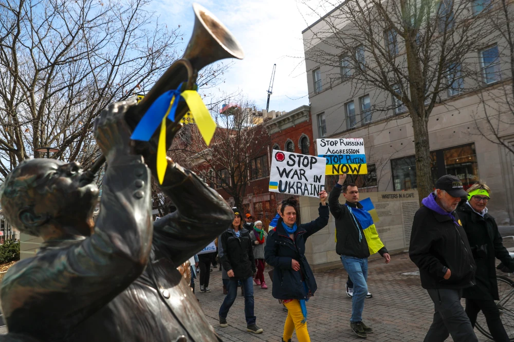 Protesters march towards the Pentacrest during a rally calling for peace and an end to the Russian Ukrainian conflict on Tuesday, March 1, 2022, in Iowa City, Iowa. (AP)